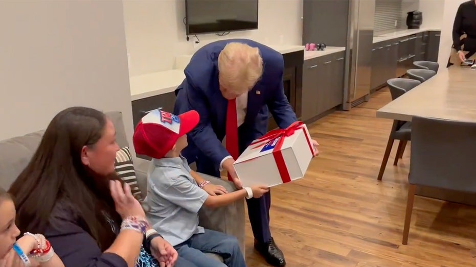 ‘Trump 2024!': Young supporter with rare brain disorder beams after surprise meeting with former president