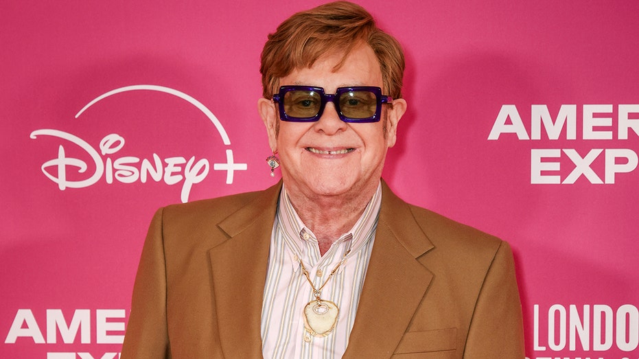 Elton John wears his old kneecap as a pendant around his neck following latest health scare